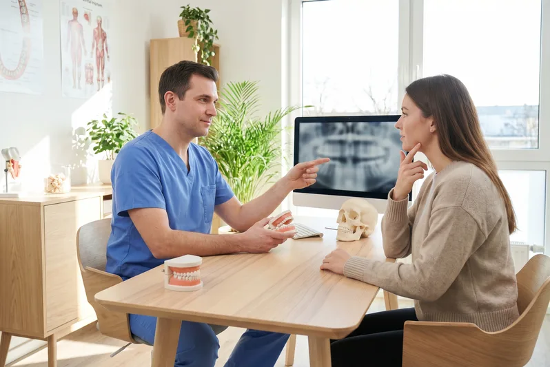 Dentist reviewing crown and bridge treatment planning with a patient
