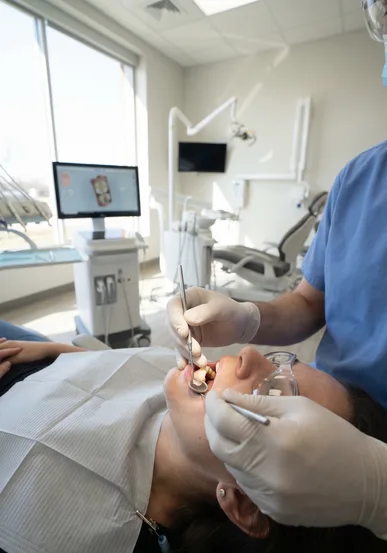 Close view of a dentist examining a tooth restoration